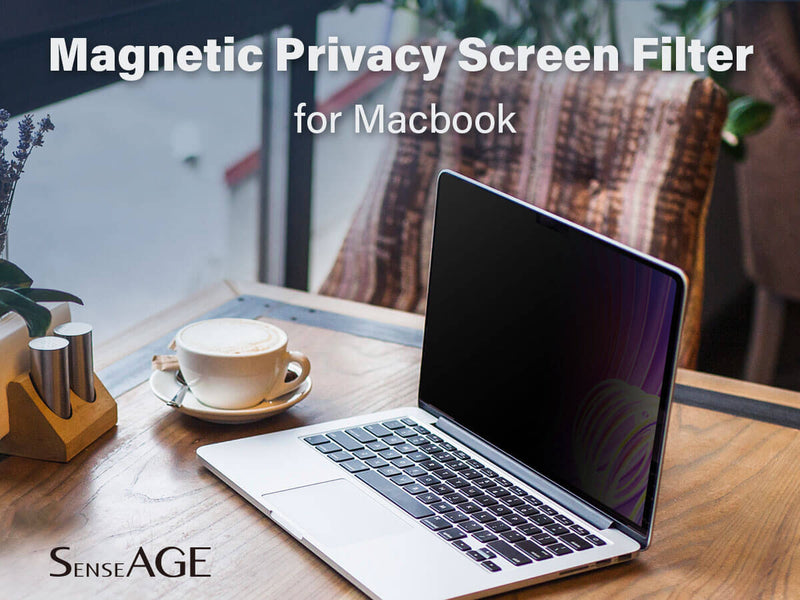 MacBook on a wooden table with a cup of coffee and plants in the background, equipped with a SenseAGE Magnetic Privacy Screen Filter that makes the screen appear dark. The text reads 'Magnetic Privacy Screen Filter for MacBook' and 'SenseAGE.