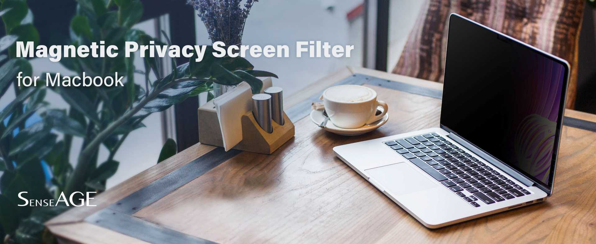 MacBook on a wooden table with a cup of coffee and plants in the background, equipped with a SenseAGE Magnetic Privacy Screen Filter that makes the screen appear dark. The text reads 'Magnetic Privacy Screen Filter for MacBook' and 'SenseAGE.